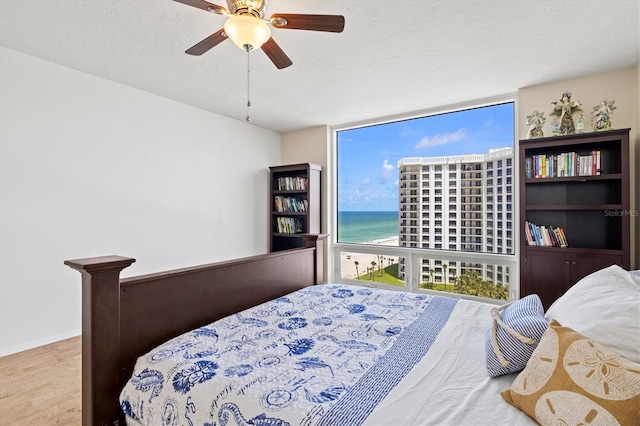 2425 Gulf Of Mexico Dr Unit 10F, Longboat Key, FL 34228 - bedroom featuring a wall of windows, a water view, and ceiling fan