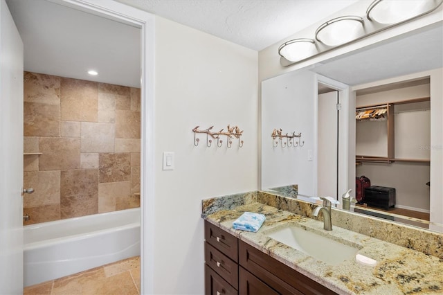 2425 Gulf Of Mexico Dr Unit 10F, Longboat Key, FL 34228 - bathroom with vanity, bathtub / shower combination, a spacious closet, and recessed lighting