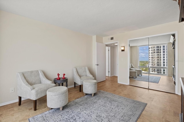 2425 Gulf Of Mexico Dr Unit 10F, Longboat Key, FL 34228 - living area featuring baseboards and wood finished floors