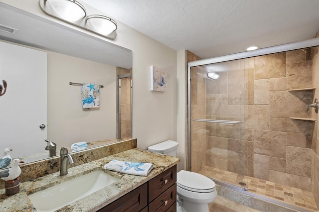 2425 Gulf Of Mexico Dr Unit 10F, Longboat Key, FL 34228 - bathroom featuring vanity, a shower stall, a textured ceiling, and recessed lighting