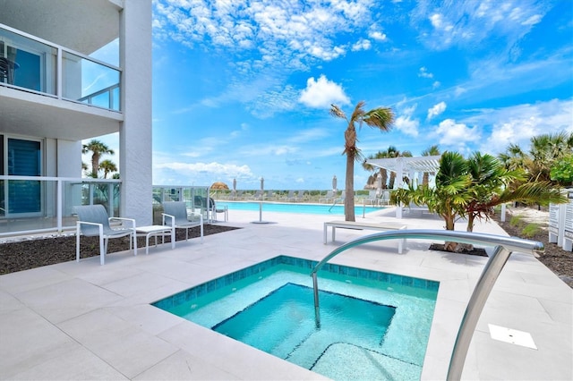 2425 Gulf Of Mexico Dr Unit 10F, Longboat Key, FL 34228 - community pool featuring a hot tub, a pergola, and a patio