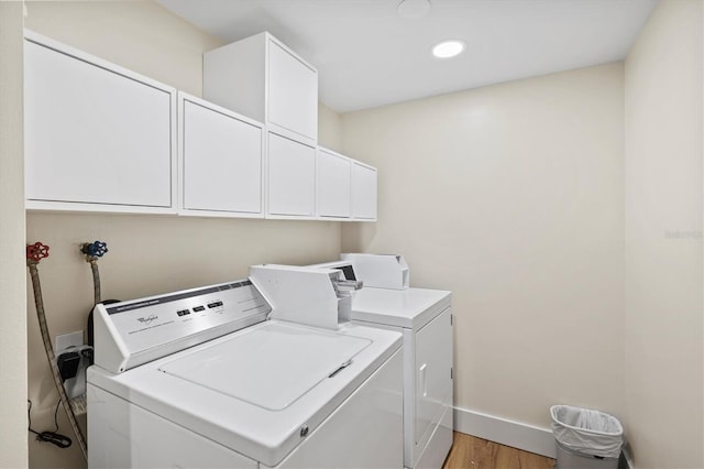 2425 Gulf Of Mexico Dr Unit 10F, Longboat Key, FL 34228 - laundry room featuring washer and clothes dryer, light wood-type flooring, cabinet space, and recessed lighting