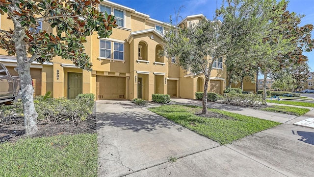 8907 White Sage Loop, Lakewood Ranch, FL 34202 - townhome / multi-family property featuring stucco siding, a garage, and driveway