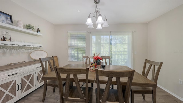 8907 White Sage Loop, Lakewood Ranch, FL 34202 - dining space featuring dark wood-style floors and a chandelier