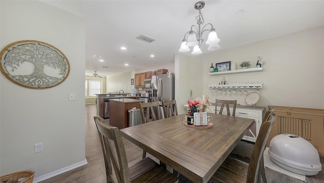 8907 White Sage Loop, Lakewood Ranch, FL 34202 - dining area featuring wood finished floors, a chandelier, and recessed lighting
