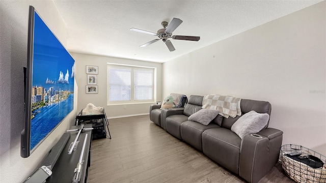 8907 White Sage Loop, Lakewood Ranch, FL 34202 - living room with wood finished floors, ceiling fan, and a textured ceiling