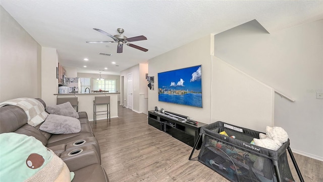 8907 White Sage Loop, Lakewood Ranch, FL 34202 - living area featuring wood finished floors, ceiling fan, and recessed lighting