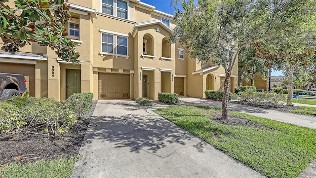 8907 White Sage Loop, Lakewood Ranch, FL 34202 - view of property featuring stucco siding, a garage, and concrete driveway