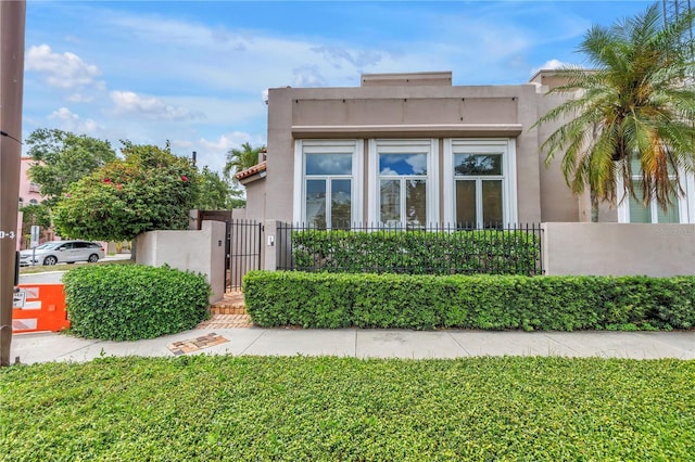 200 Cocoanut Ave Unit 1, Sarasota, FL 34236 - view of property exterior featuring stucco siding and a gate
