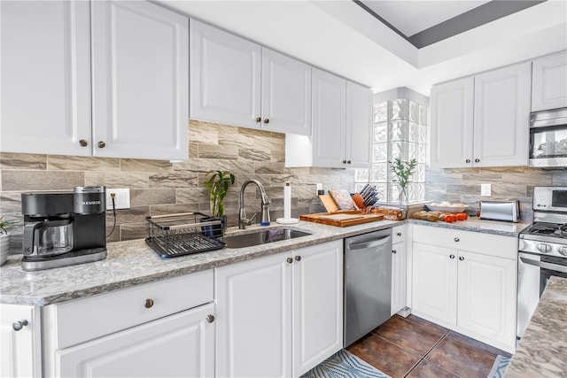 200 Cocoanut Ave Unit 1, Sarasota, FL 34236 - kitchen featuring stainless steel appliances, white cabinetry, backsplash, and light stone countertops