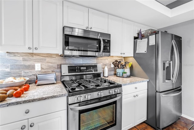 200 Cocoanut Ave Unit 1, Sarasota, FL 34236 - kitchen featuring appliances with stainless steel finishes, white cabinets, decorative backsplash, and light stone counters