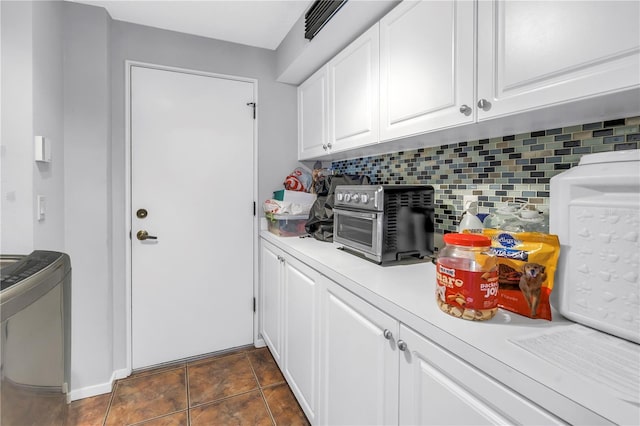 200 Cocoanut Ave Unit 1, Sarasota, FL 34236 - kitchen with decorative backsplash, light countertops, and white cabinetry