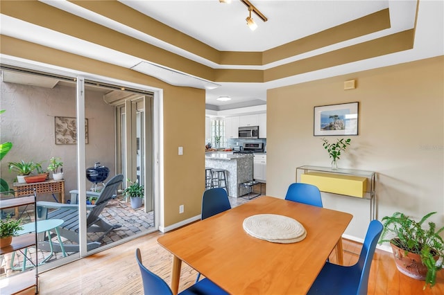 200 Cocoanut Ave Unit 1, Sarasota, FL 34236 - dining room with light wood-type flooring and rail lighting