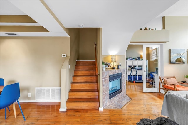 200 Cocoanut Ave Unit 1, Sarasota, FL 34236 - staircase featuring hardwood / wood-style flooring and a fireplace