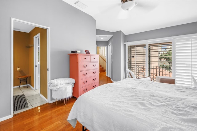 200 Cocoanut Ave Unit 1, Sarasota, FL 34236 - bedroom featuring vaulted ceiling, wood finished floors, and connected bathroom