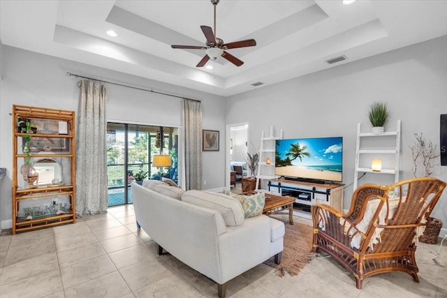 529 Sunset Rd N, Rotonda West, FL 33947 - living room with a tray ceiling, ceiling fan, recessed lighting, and light tile patterned floors