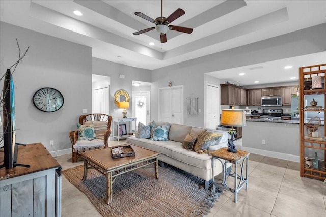 529 Sunset Rd N, Rotonda West, FL 33947 - living area with a tray ceiling, recessed lighting, ceiling fan, and light tile patterned flooring