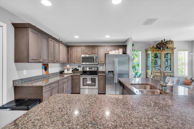529 Sunset Rd N, Rotonda West, FL 33947 - kitchen with stainless steel appliances, healthy amount of natural light, dark stone counters, and recessed lighting