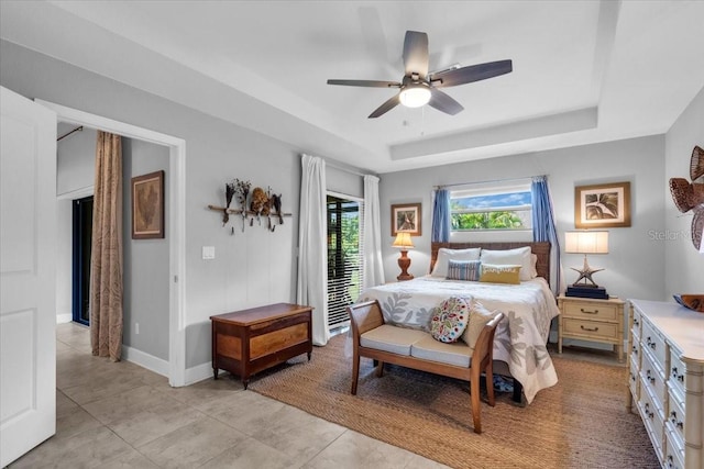 529 Sunset Rd N, Rotonda West, FL 33947 - bedroom featuring a raised ceiling, light tile patterned floors, and a ceiling fan