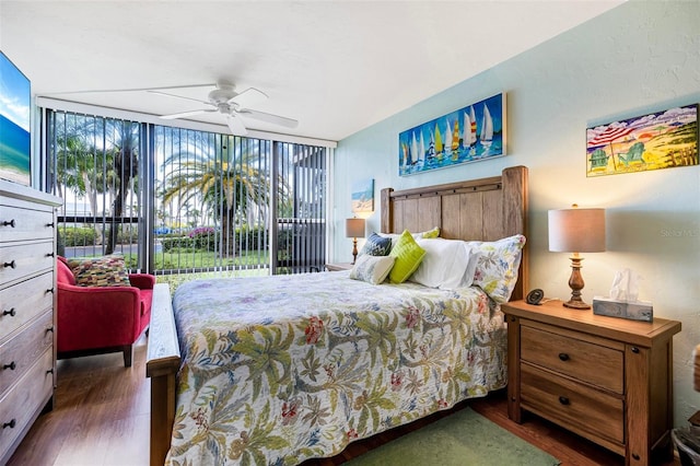 618 Bird Bay Dr S Unit 113, Venice, FL 34285 - bedroom featuring wood finished floors, expansive windows, and a ceiling fan