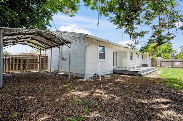 3310 W 9th Ave, Bradenton, FL 34205 - rear view of property with a deck, a fenced backyard, and a detached carport