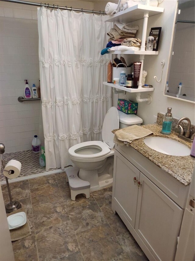 6132 29th Ave W, Bradenton, FL 34209 - bathroom featuring vanity, tiled shower, and stone finish floors