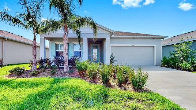 6120 115th Ave E, Parrish, FL 34219 - view of front of home with a garage, concrete driveway, and stucco siding