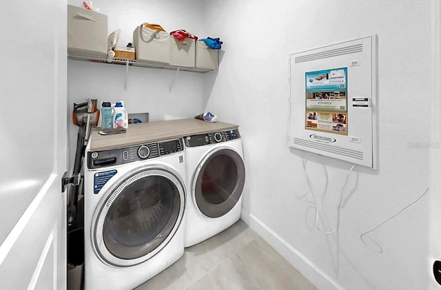 6120 115th Ave E, Parrish, FL 34219 - laundry area with washing machine and clothes dryer and light tile patterned floors