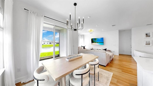6120 115th Ave E, Parrish, FL 34219 - dining room featuring a chandelier, light wood-style flooring, and a desk