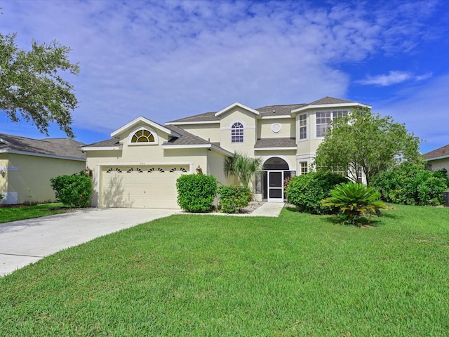 5184 51st Ln W, Bradenton, FL 34210 - view of front of home featuring stucco siding, a front yard, driveway, and a garage