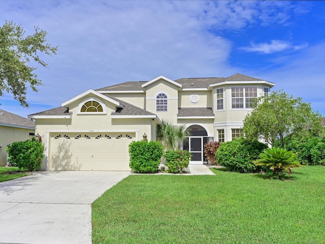 5184 51st Ln W, Bradenton, FL 34210 - traditional-style home with a front lawn, concrete driveway, stucco siding, and an attached garage