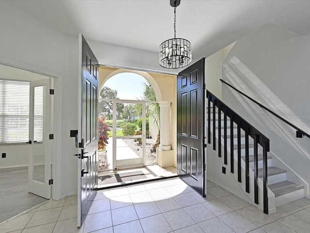 5184 51st Ln W, Bradenton, FL 34210 - entryway with a chandelier, light tile patterned flooring, and stairway