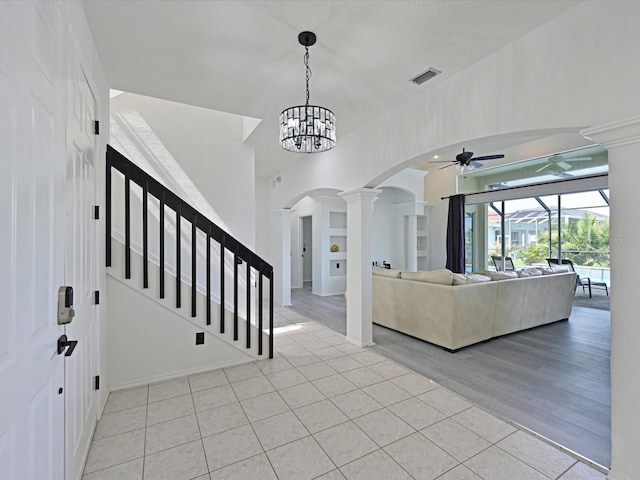 5184 51st Ln W, Bradenton, FL 34210 - entrance foyer with arched walkways, ornate columns, ceiling fan, light tile patterned floors, and stairs