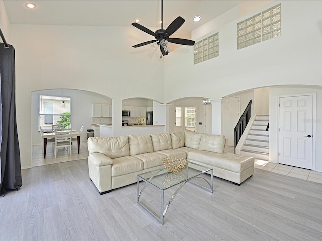5184 51st Ln W, Bradenton, FL 34210 - living area with arched walkways, a ceiling fan, plenty of natural light, light wood finished floors, and a towering ceiling