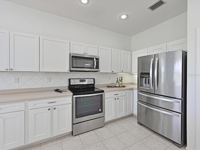 5184 51st Ln W, Bradenton, FL 34210 - kitchen featuring stainless steel appliances, white cabinets, light countertops, tasteful backsplash, and recessed lighting