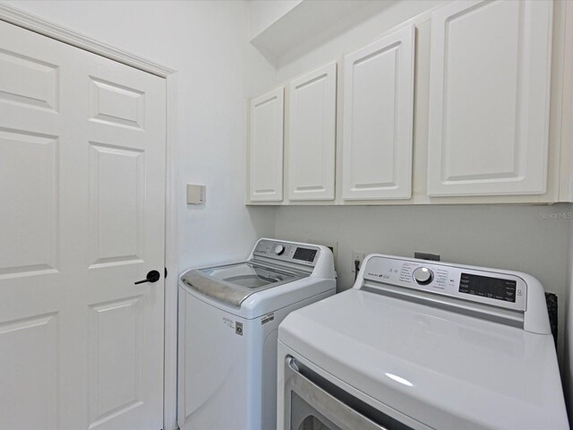 5184 51st Ln W, Bradenton, FL 34210 - washroom featuring cabinet space and separate washer and dryer