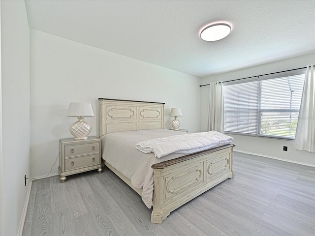 5184 51st Ln W, Bradenton, FL 34210 - bedroom with light wood-style flooring and a textured ceiling