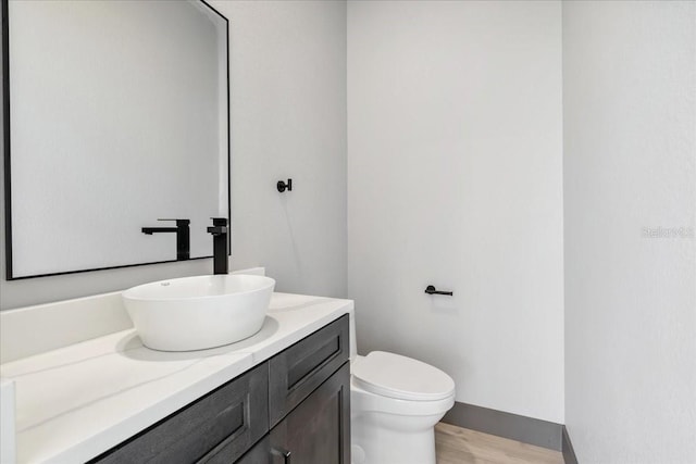 9150 Key W St, Port Charlotte, FL 33981 - half bathroom featuring vanity and wood finished floors