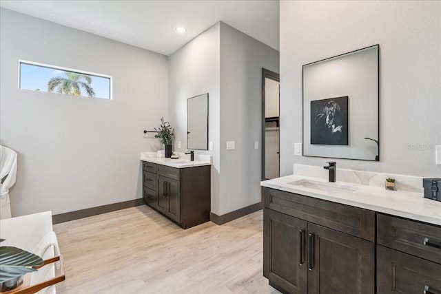 9150 Key W St, Port Charlotte, FL 33981 - bathroom with two vanities, wood finished floors, and recessed lighting