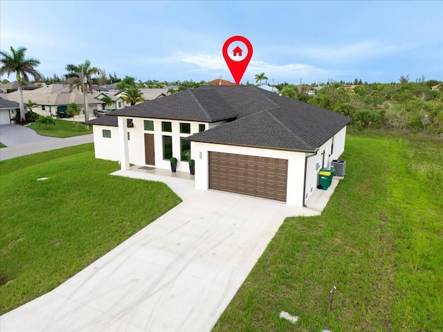 9150 Key W St, Port Charlotte, FL 33981 - view of front of house featuring a garage, stucco siding, driveway, and a front yard