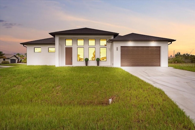 9150 Key W St, Port Charlotte, FL 33981 - prairie-style house featuring stucco siding, a garage, and driveway