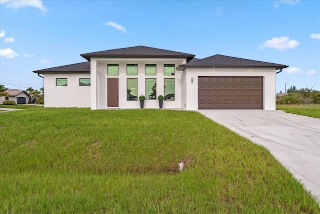 9150 Key W St, Port Charlotte, FL 33981 - prairie-style home featuring stucco siding, an attached garage, driveway, and a front yard