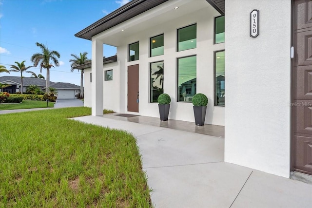 9150 Key W St, Port Charlotte, FL 33981 - entrance to property featuring a yard and stucco siding