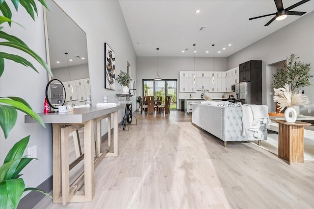 9150 Key W St, Port Charlotte, FL 33981 - living area with a ceiling fan, light wood-type flooring, a towering ceiling, and recessed lighting