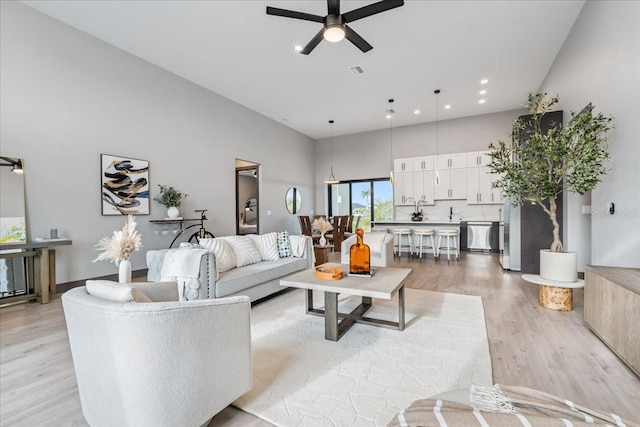 9150 Key W St, Port Charlotte, FL 33981 - living area featuring ceiling fan, a towering ceiling, light wood-style floors, and recessed lighting