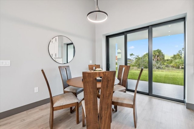 9150 Key W St, Port Charlotte, FL 33981 - dining area featuring light wood-style floors and a high ceiling