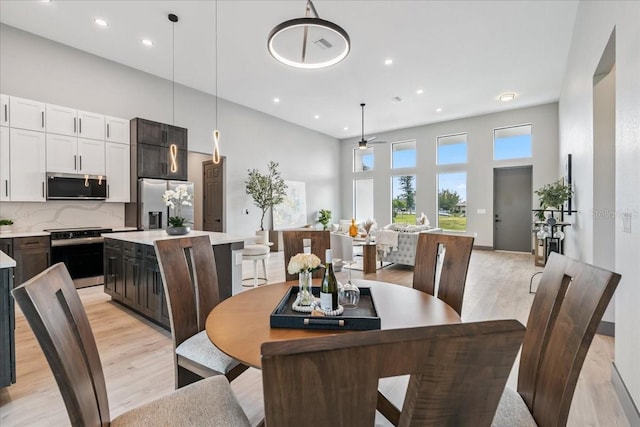 9150 Key W St, Port Charlotte, FL 33981 - dining area featuring light wood-type flooring, a towering ceiling, recessed lighting, and ceiling fan