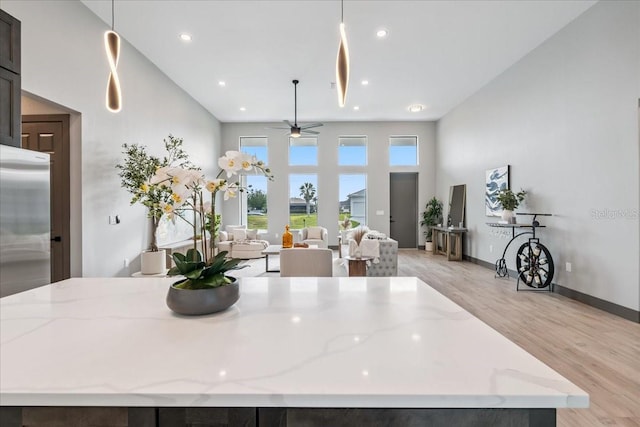 9150 Key W St, Port Charlotte, FL 33981 - dining room featuring light wood finished floors, a towering ceiling, a ceiling fan, and recessed lighting