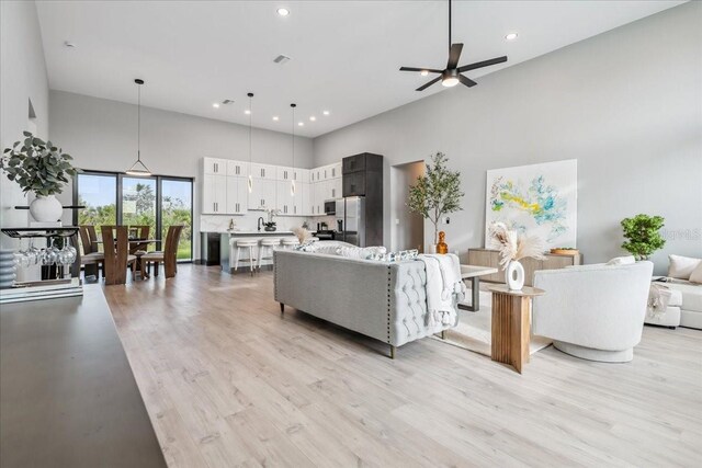 9150 Key W St, Port Charlotte, FL 33981 - living area with a towering ceiling, ceiling fan, light wood-type flooring, and recessed lighting