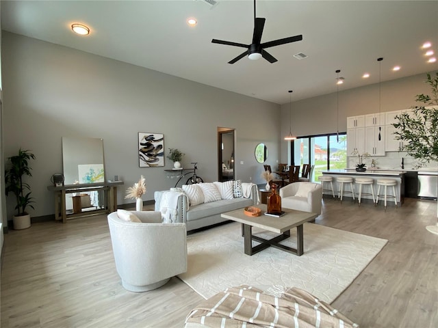 9150 Key W St, Port Charlotte, FL 33981 - living room featuring a towering ceiling, light wood-type flooring, a ceiling fan, and recessed lighting